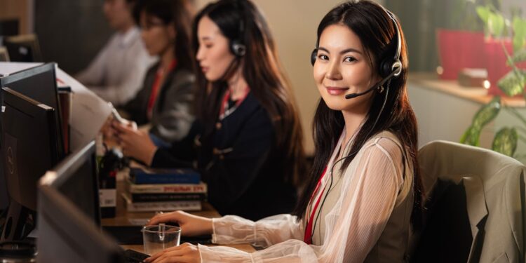Professionals working together in a modern office, highlighting teamwork, communication, and productivity. Young beautiful operator girl