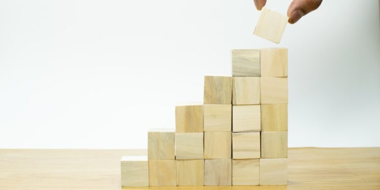 Businessman hand putting blank wooden cube block stack on white background with copy space for input text, icon, trend, creative idea, finance, leadership, strategy, business, online marketing concept