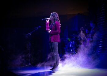 Female singer on stage with fog all around from a fog machine.