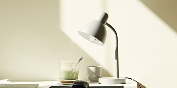 At home work desk with Matcha Tea, Mouse, Laptop and Lamp.