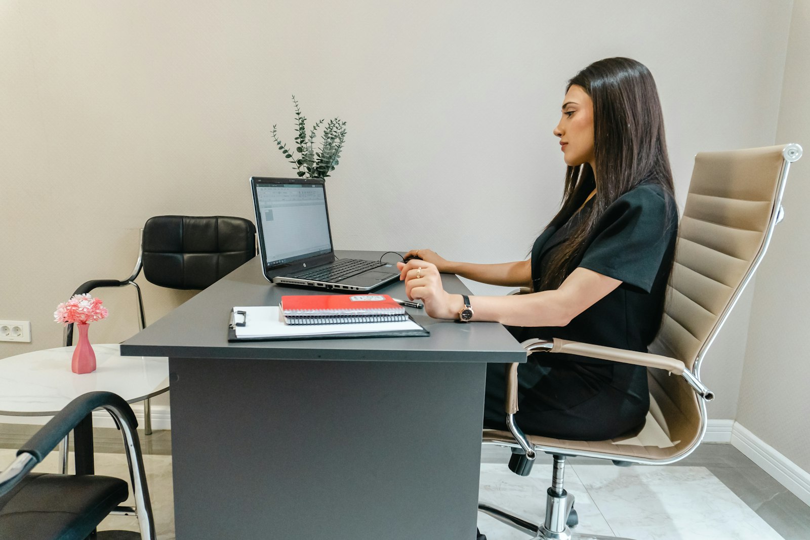 Woman working on laptop at office desk