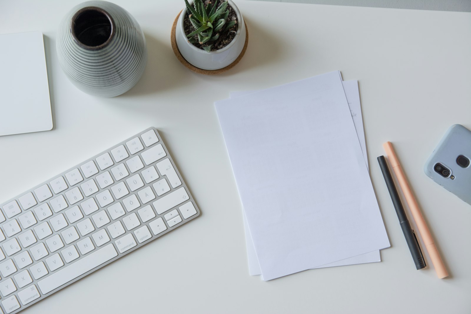 Ondernemer scant bonnetjes en facturen aan een bureau met ordners