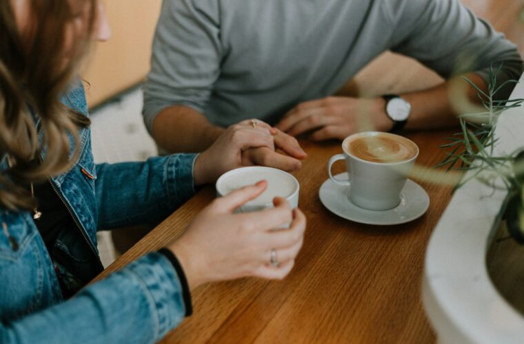 Leidinggevende en medewerker voeren een een-op-een-gesprek met koffie